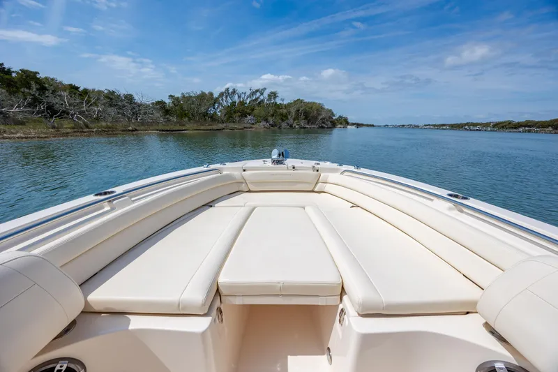 Slide: The Image of 2024 Grady-White Fisherman 236 boat on serene water with lush shoreline. - 18