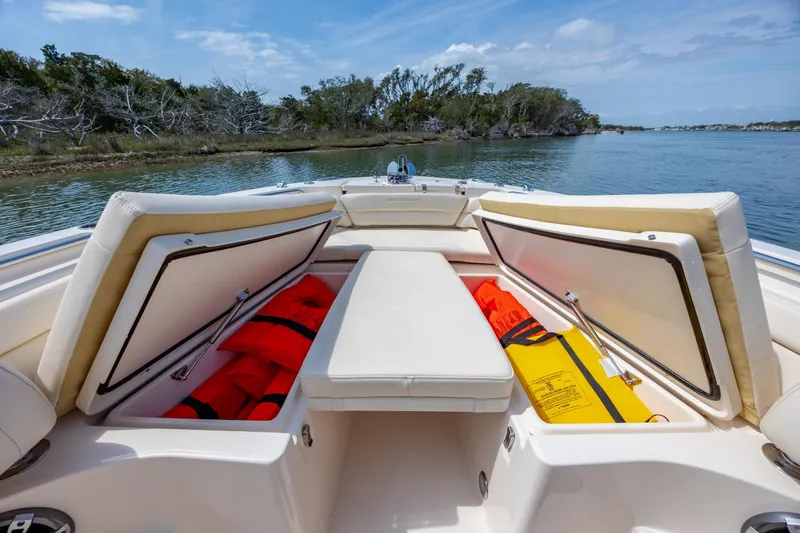 Slide: The Image of 2024 Grady-White Fisherman 236 boat with open storage compartments and life jackets. - 19