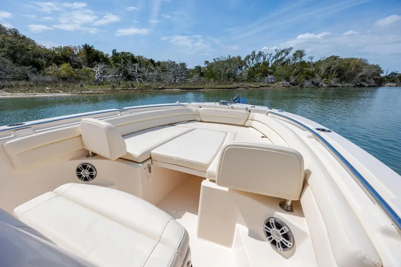 Slide: The Image of 2024 Grady-White Fisherman 236 boat interior with comfortable seating on calm water. - 21