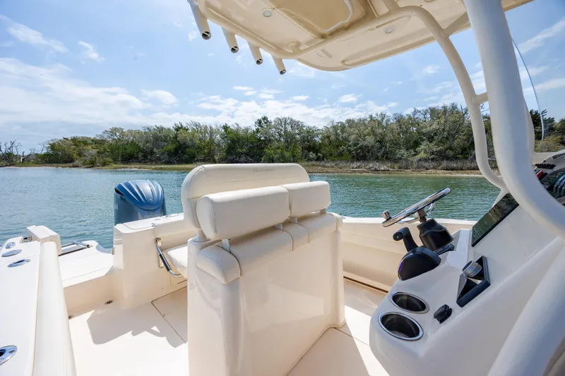 Slide: The Image of 2024 Grady-White Fisherman 236 boat interior with helm and seating, on a serene waterway. - 29