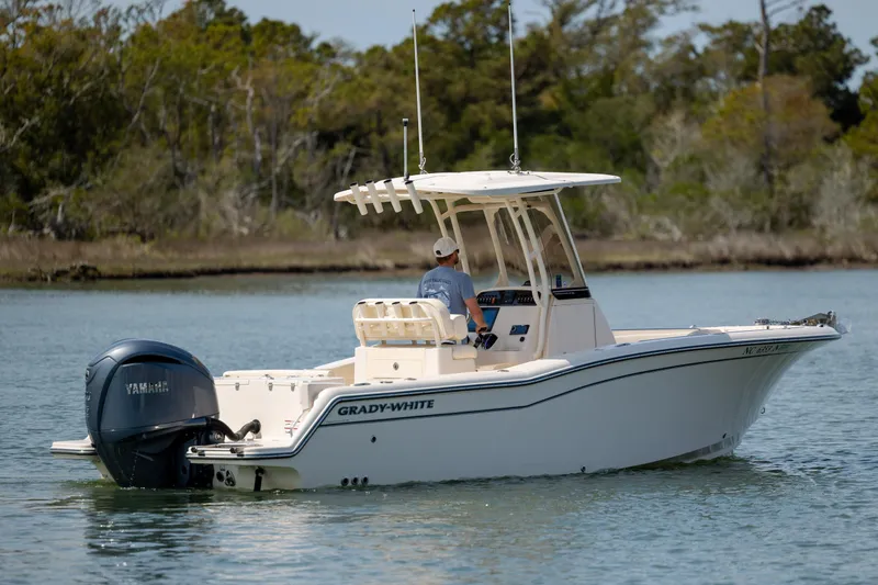 Slide: The Image of 2024 Grady-White Fisherman 236 boat cruising on calm water with Yamaha outboard engine. - 3