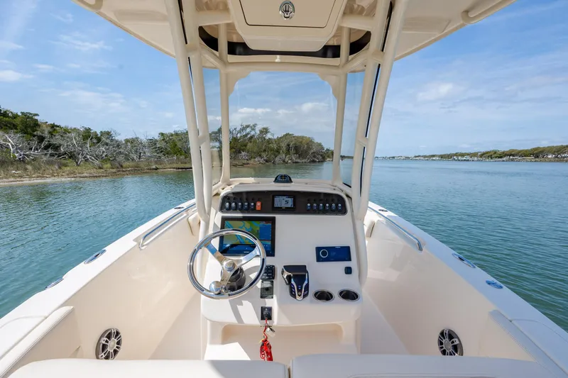 Slide: The Image of 2024 Grady-White Fisherman 236 boat dashboard with scenic waterway view. - 32