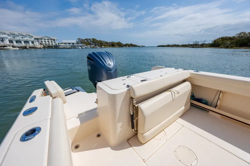 Slide: The Image of 2024 Grady-White Fisherman 236 boat on calm water, showcasing spacious seating and sleek design. - 36