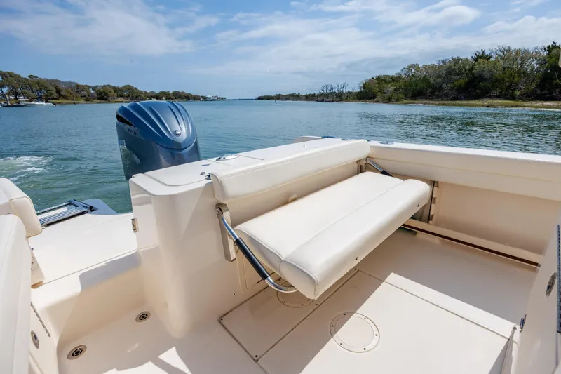 Slide: The Image of 2024 Grady-White Fisherman 236 boat with foldable seating and Yamaha outboard motor. - 37