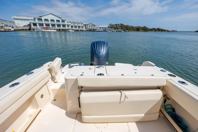 Slide: The Image of 2024 Grady-White Fisherman 236 boat on calm water near a marina. - 38