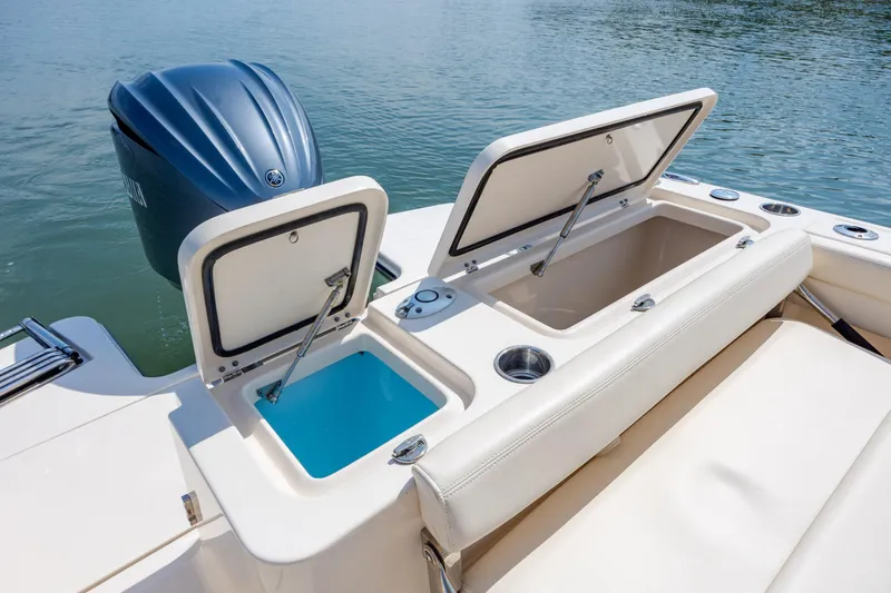 Slide: The Image of 2024 Grady-White Fisherman 236 boat with open storage compartments and outboard motor. - 39
