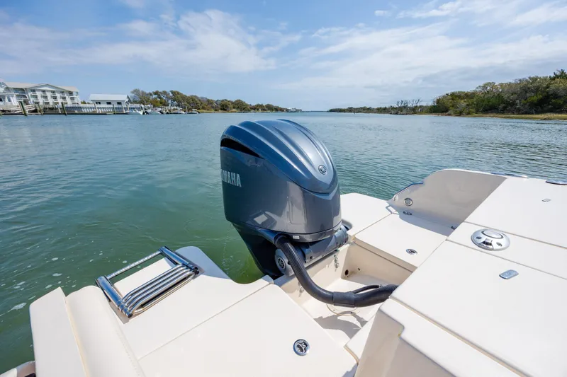 Slide: The Image of 2024 Grady-White Fisherman 236 boat with Yamaha outboard motor on calm water. - 40