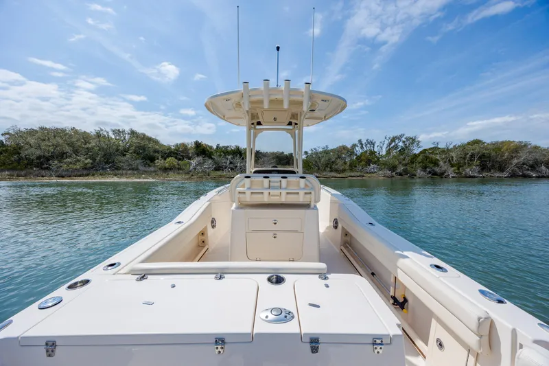 Slide: The Image of 2024 Grady-White Fisherman 236 boat on calm water, clear sky background. - 42