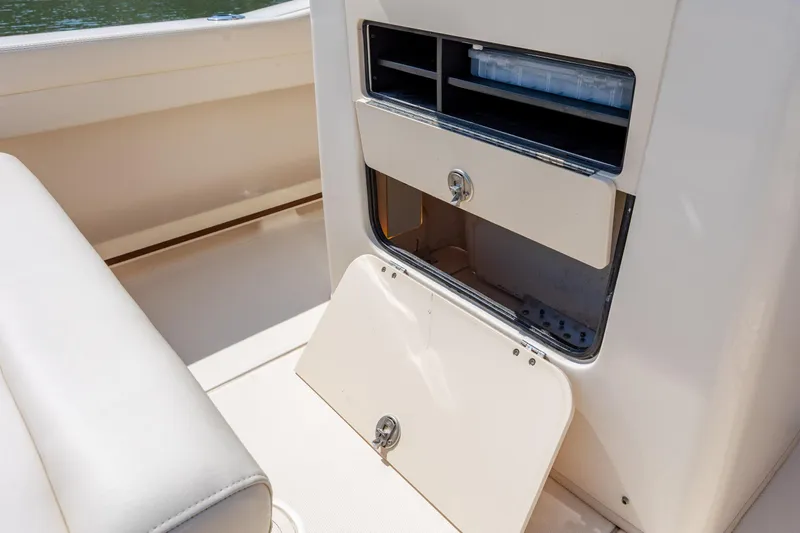 Slide: The Image of 2024 Grady-White Fisherman 236 boat storage compartment with open hatch and seating. - 43