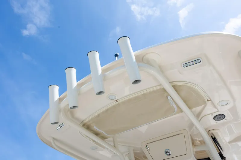 Slide: The Image of 2024 Grady-White Fisherman 236 boat top view with rod holders against blue sky. - 48