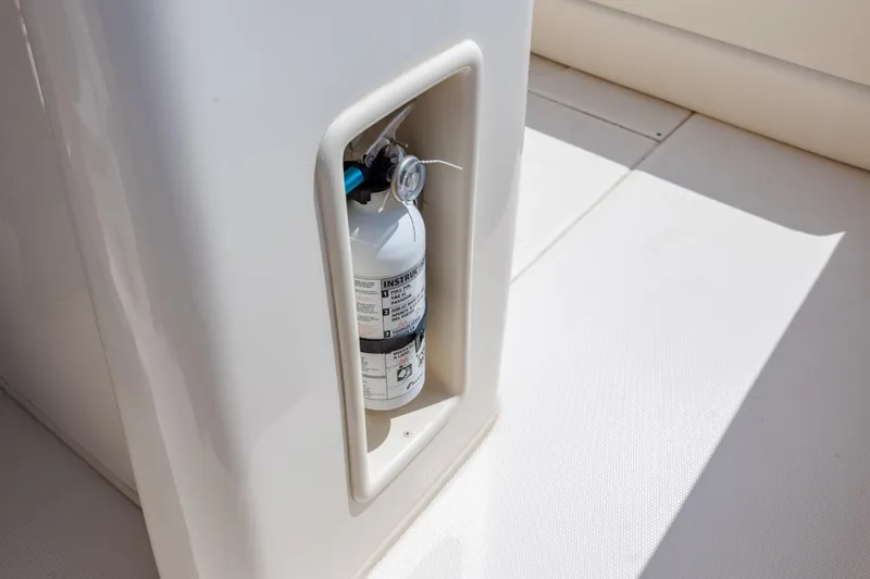 Slide: The Image of Fire extinguisher on 2024 Grady-White Fisherman 236 boat, securely mounted in compartment. - 51