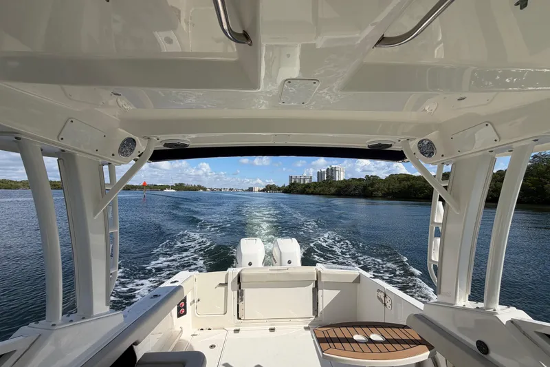 Slide: The Image of 2021 Boston Whaler 280 Vantage cruising on a scenic waterway with clear skies. - 18