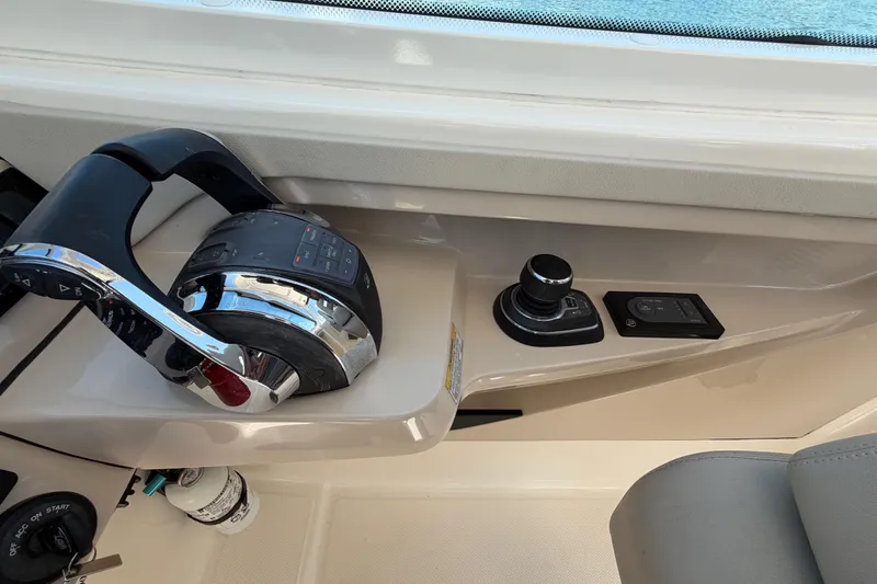 Slide: The Image of Control panel of a 2021 Boston Whaler 280 Vantage boat, featuring modern throttle and joystick. - 21