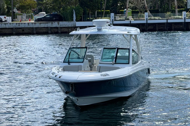 Slide: The Image of 2021 Boston Whaler 280 Vantage boat cruising on a calm waterway. - 29