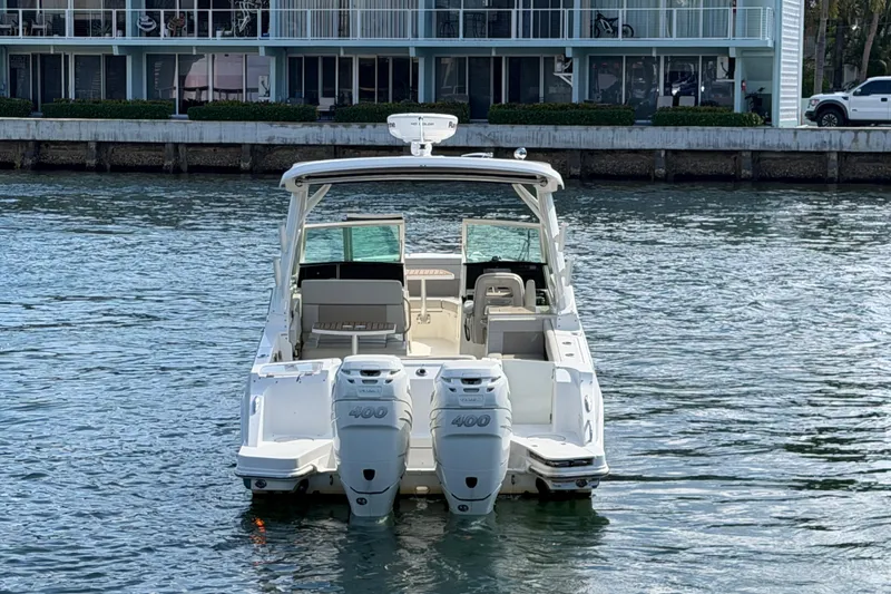 Slide: The Image of 2021 Boston Whaler 280 Vantage boat with dual engines on water near dock. - 32