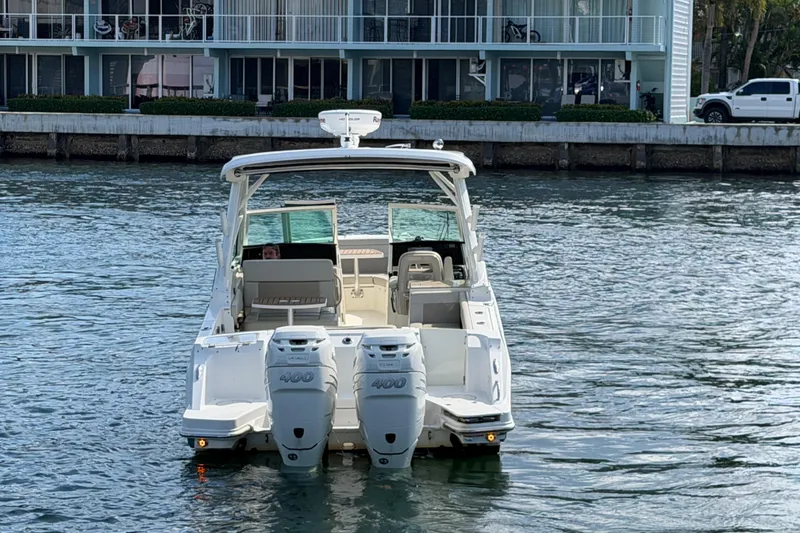 Slide: The Image of 2021 Boston Whaler 280 Vantage boat on water near waterfront buildings. - 36