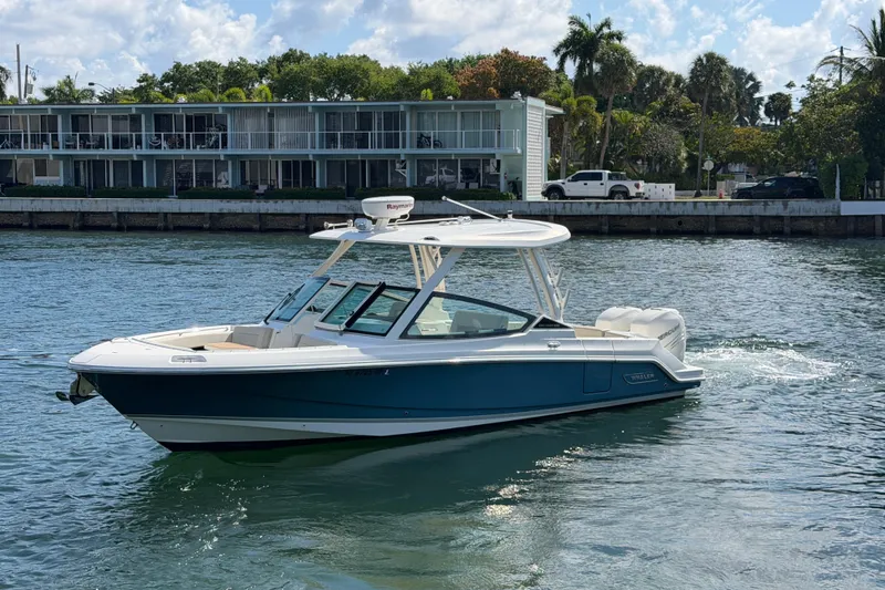Slide: The Image of 2021 Boston Whaler 280 Vantage boat cruising on a sunny waterfront. - 37