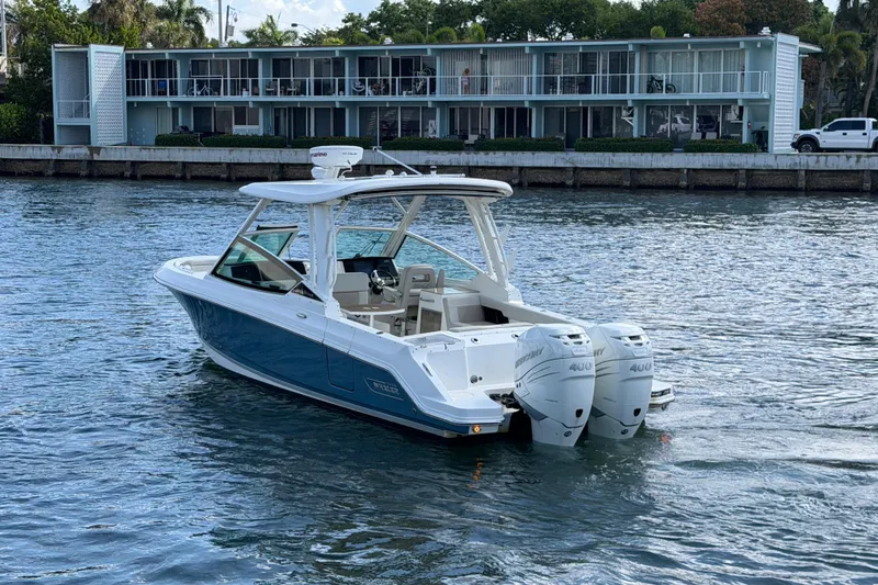 Slide: The Image of 2021 Boston Whaler 280 Vantage boat with twin engines on a calm waterway. - 38