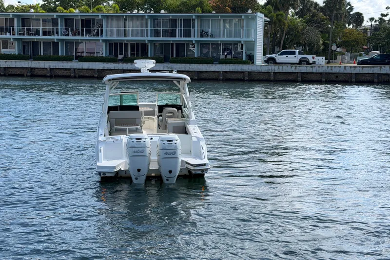 Slide: The Image of 2021 Boston Whaler 280 Vantage boat on water near waterfront buildings. - 40