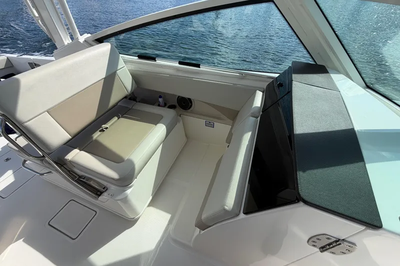Slide: The Image of 2021 Boston Whaler 280 Vantage interior with cushioned seating and ocean view. - 8
