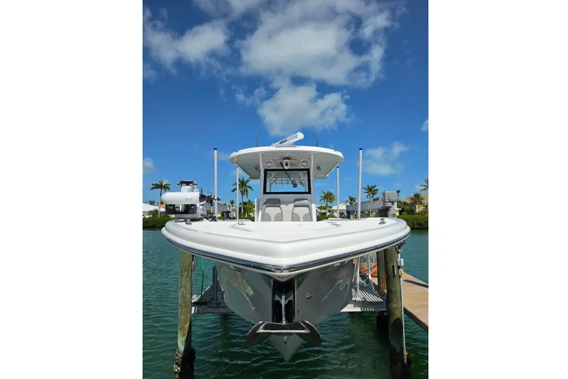 Slide: The Image of 2024 Sea Pro 322 Offshore boat at dock under blue sky. - 15