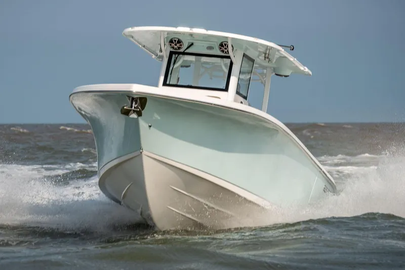 Slide: The Image of 2024 Sea Pro 322 Offshore boat docked on a sunny day with blue skies. - 2