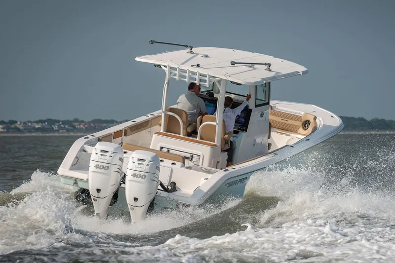 Slide: The Image of 2024 Sea Pro 322 Offshore boat with Suzuki engine docked on clear water. - 3