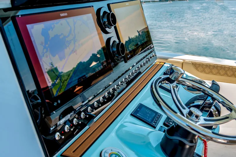 Slide: The Image of 2024 Sea Pro 322 Offshore boat with dual Suzuki 350 engines on turquoise water. - 5