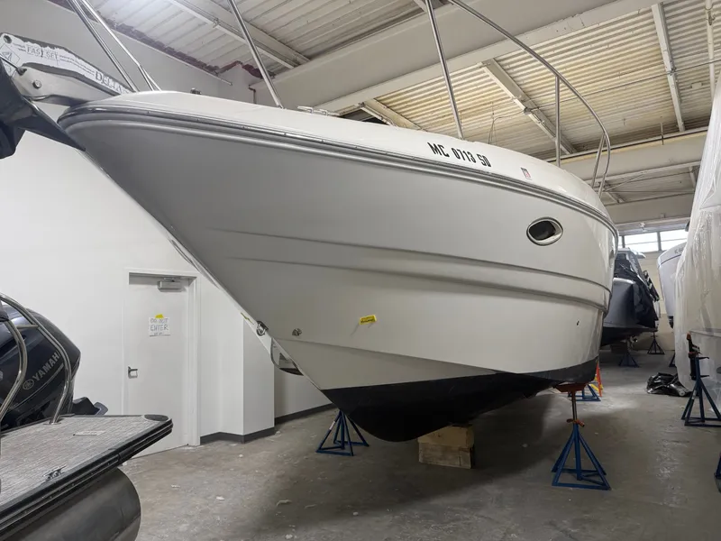 The Image of 2001 Larson Cabrio 330 boat stored indoors on stands. - 0
