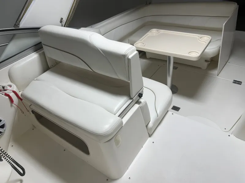 Slide: The Image of Interior of 2001 Larson Cabrio 330 boat with white seating. - 10