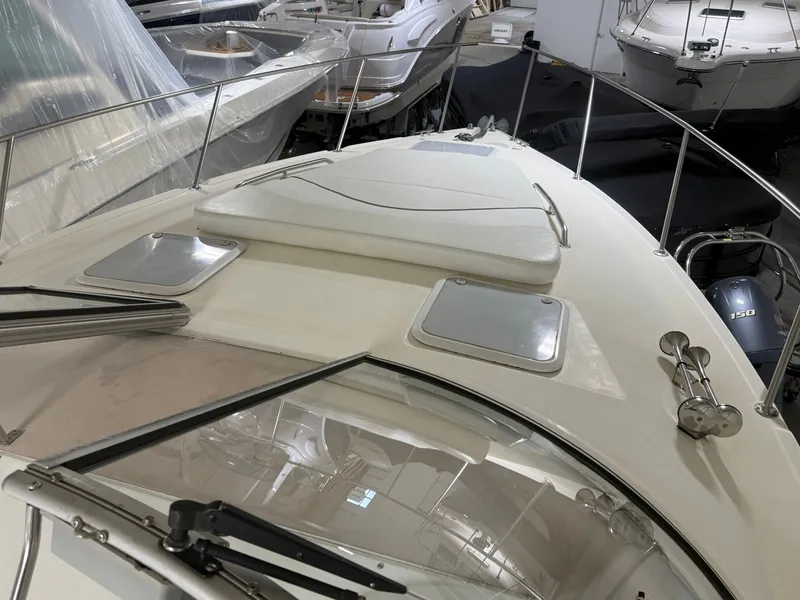 Slide: The Image of 2001 Larson Cabrio 330 boat deck in a marina. - 11