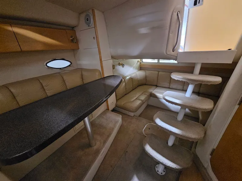 Slide: The Image of Interior of a 2001 Larson Cabrio 330 yacht with seating area and stairs. - 14