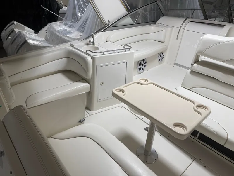 Slide: The Image of Interior of a 2001 Larson Cabrio 330 yacht with seating area and table. - 2