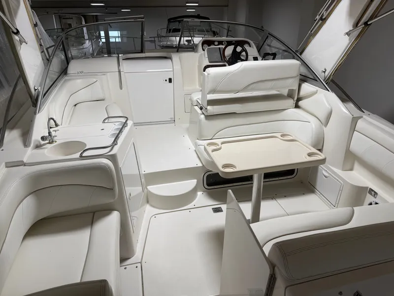 Slide: The Image of Interior of a 2001 Larson Cabrio 330 yacht with white seating. - 4