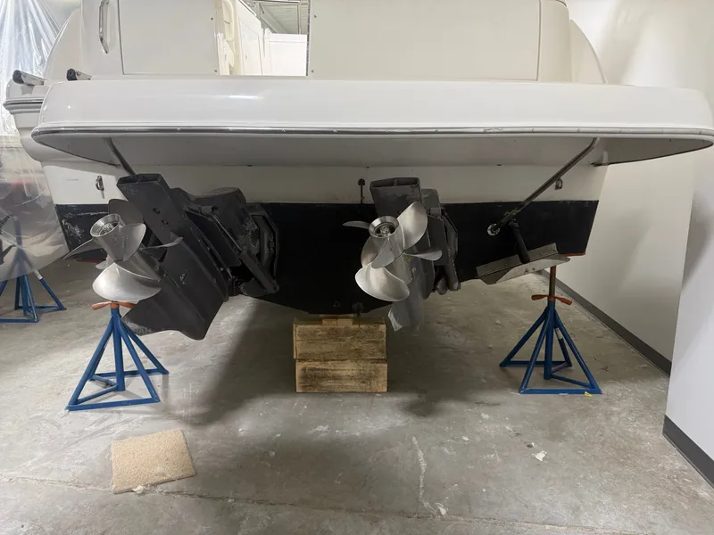 Slide: The Image of Rear view of a 2001 Larson Cabrio 330 boat on stands. - 6