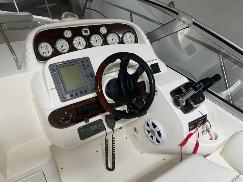 Slide: The Image of 2001 Larson Cabrio 330 boat helm with instruments and controls. - 8