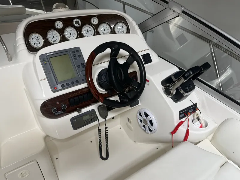 Slide: The Image of 2001 Larson Cabrio 330 boat helm with instruments and controls. - 9