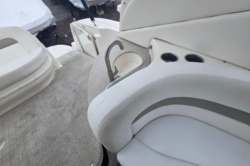 Slide: The Image of 2003 Sea Ray Sundancer 320 interior with seating, sink, and cup holders. - 11