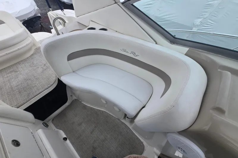 Slide: The Image of Interior seating of a 2003 Sea Ray Sundancer 320 boat, featuring white upholstery. - 12