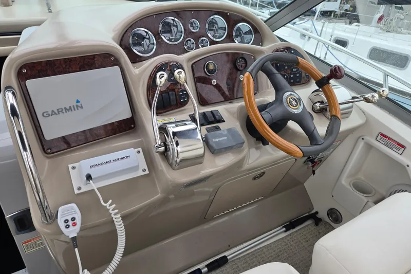 Slide: The Image of Cockpit of 2003 Sea Ray Sundancer 320 with Garmin navigation and wood-accented steering wheel. - 13