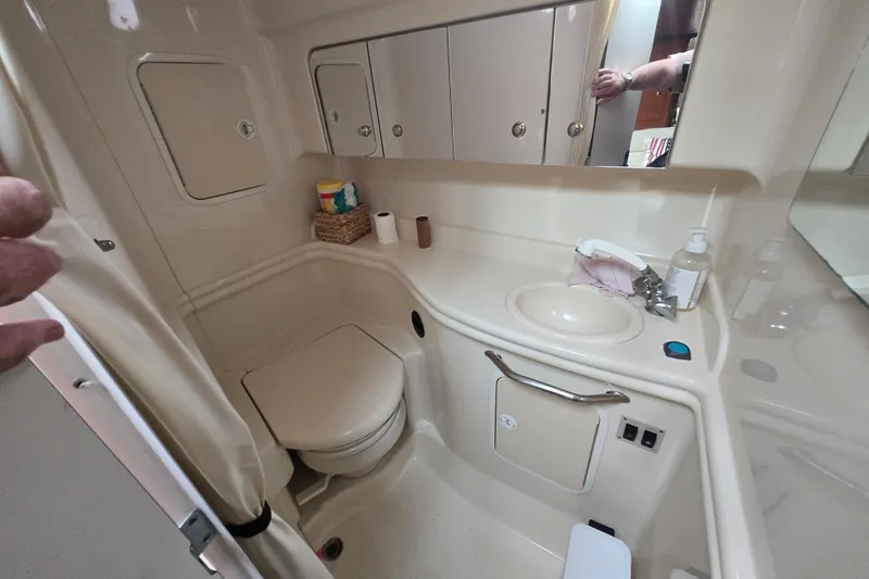 Slide: The Image of 2003 Sea Ray Sundancer 320 bathroom with sink, toilet, and storage cabinets. - 15