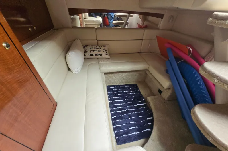 Slide: The Image of Interior of 2003 Sea Ray Sundancer 320 with cozy seating and nautical decor. - 16