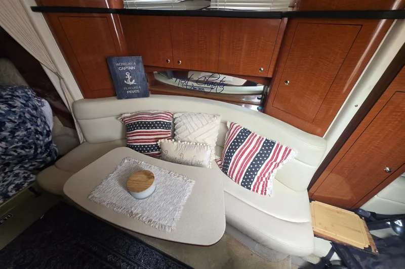 Slide: The Image of Interior of a 2003 Sea Ray Sundancer 320 with cozy seating and decorative pillows. - 17