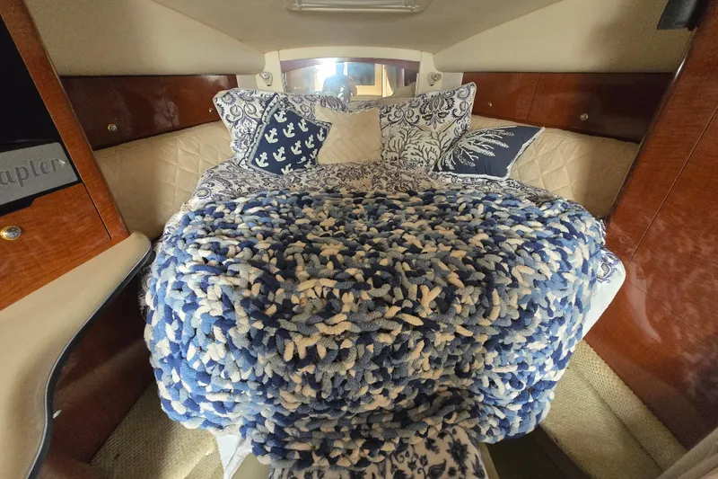 Slide: The Image of Cozy cabin interior of 2003 Sea Ray Sundancer 320 with nautical-themed bedding. - 20