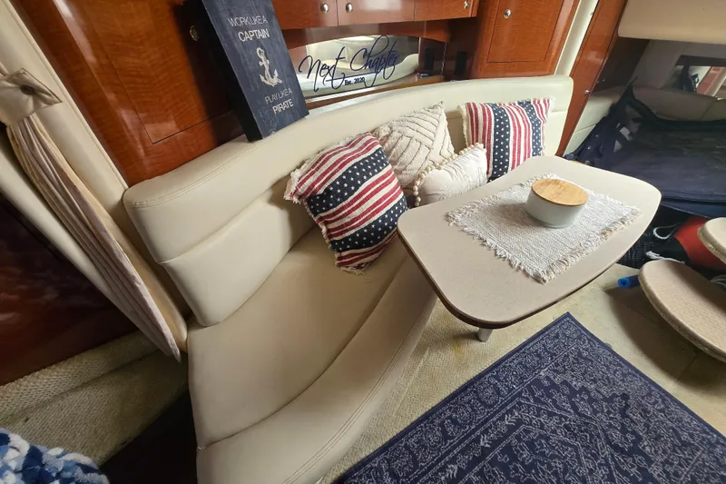 Slide: The Image of Interior of 2003 Sea Ray Sundancer 320 with cozy seating and nautical decor. - 21