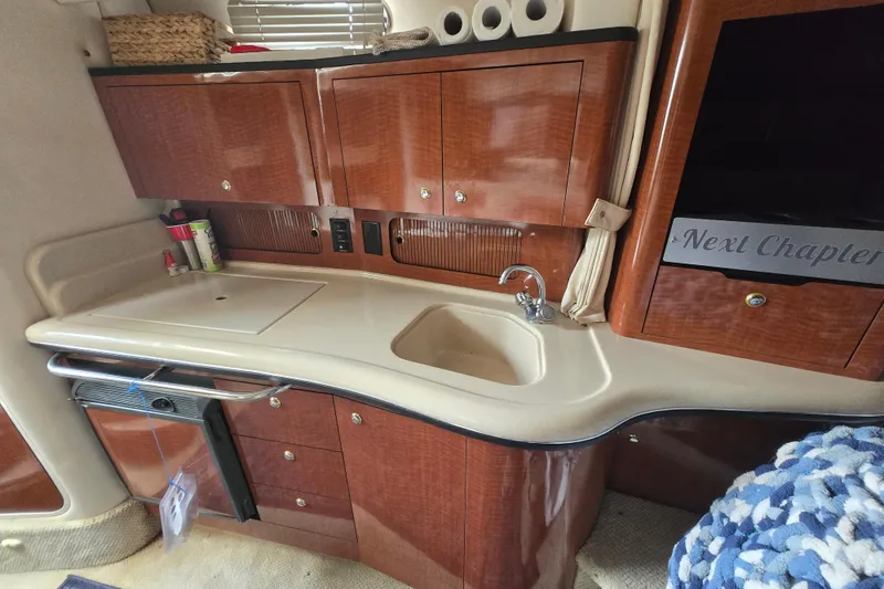 Slide: The Image of Interior of 2003 Sea Ray Sundancer 320 yacht with kitchenette and wooden cabinetry. - 22