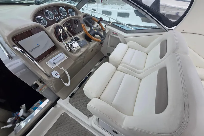 Slide: The Image of Interior cockpit of 2003 Sea Ray Sundancer 320 with Garmin navigation system and plush seating. - 3
