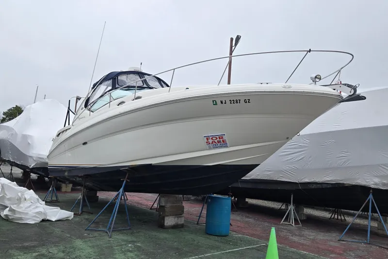 Slide: The Image of 2003 Sea Ray Sundancer 320 boat on stands, for sale, with visible registration number. - 5