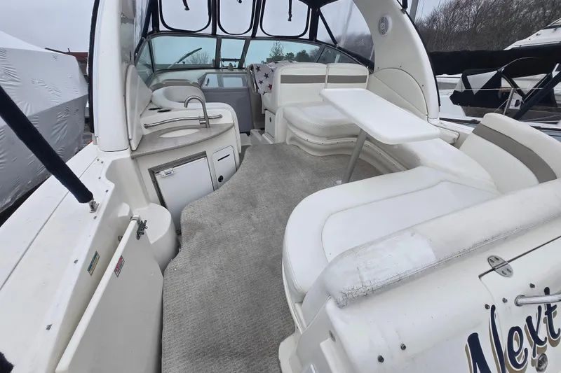 Slide: The Image of 2003 Sea Ray Sundancer 320 interior with seating, table, and kitchenette. - 6