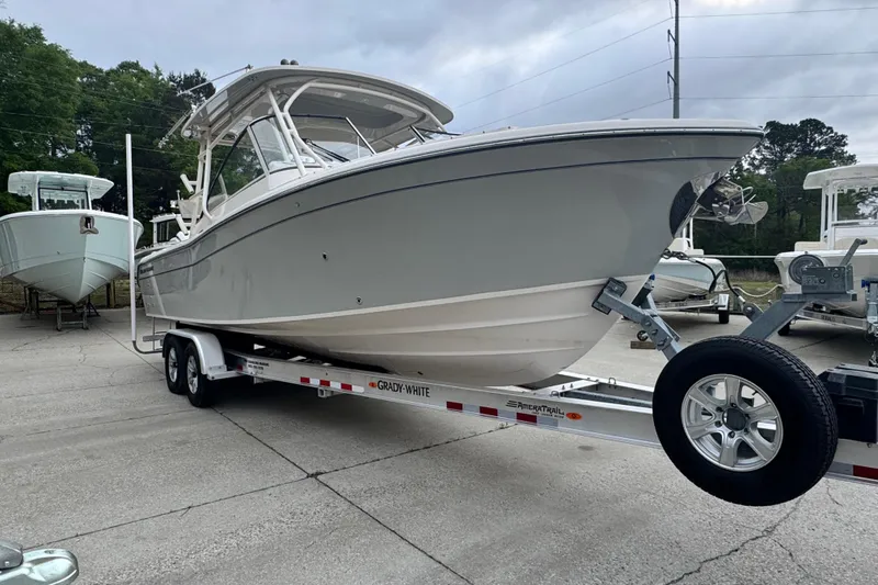 Slide: The Image of 2023 Grady-White Freedom 285 boat on trailer, parked outdoors. - 2